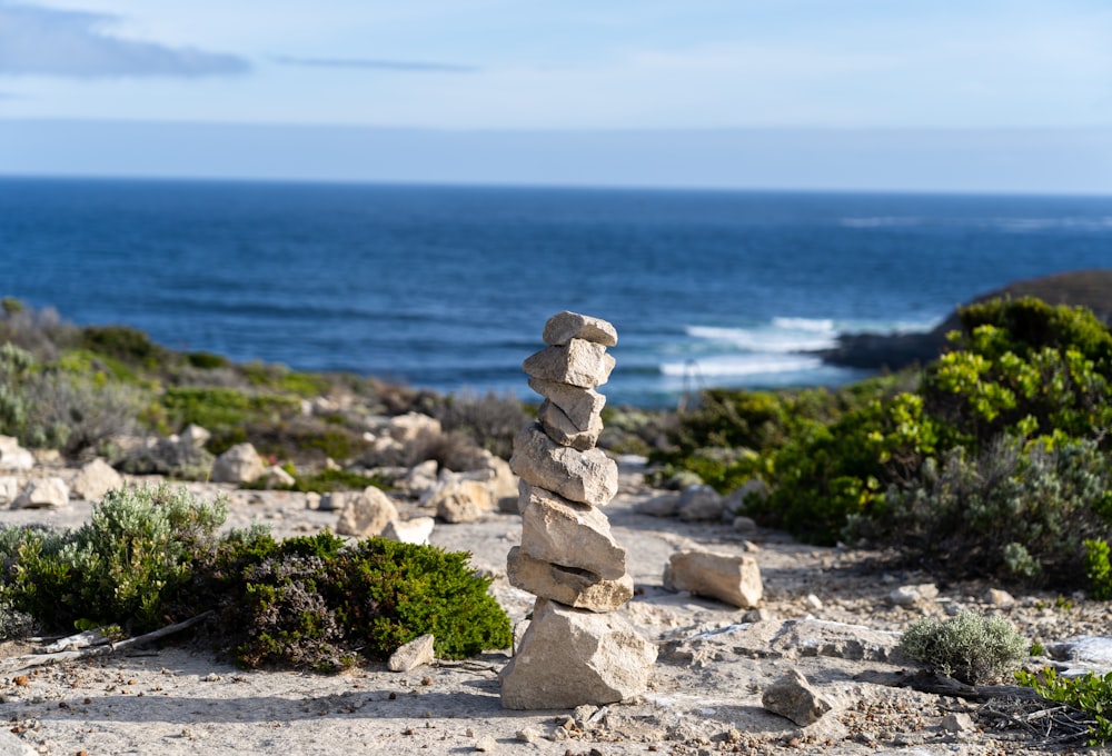 a stack of rocks sitting on top of a sandy beach