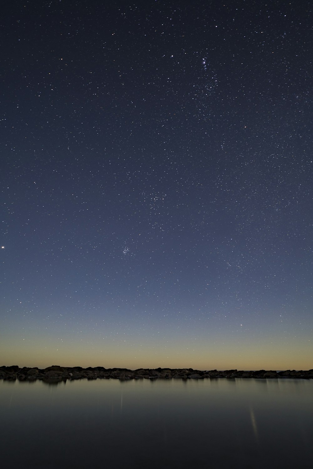 the night sky over a body of water