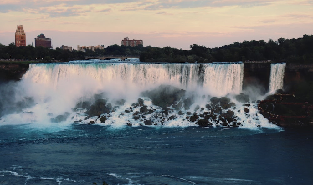 a view of a waterfall in the middle of the water