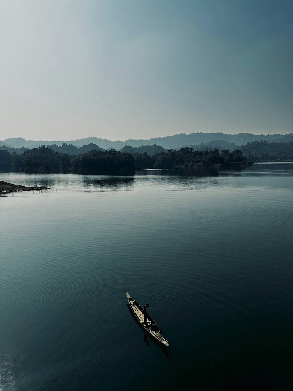 a man in a boat on a large body of water