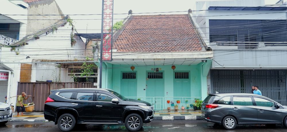 a couple of cars parked in front of a house