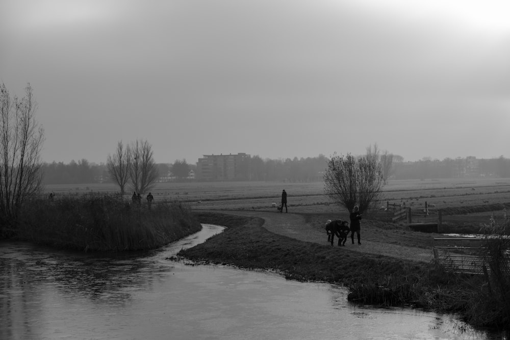 a black and white photo of two people on horses