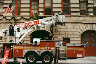 a fire truck parked in front of a tall building