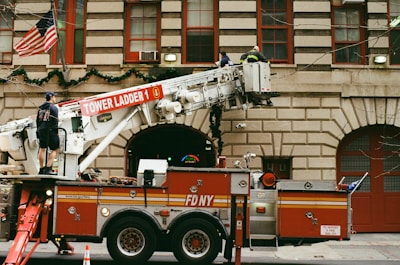 a fire truck parked in front of a tall building