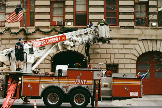 a fire truck parked in front of a tall building
