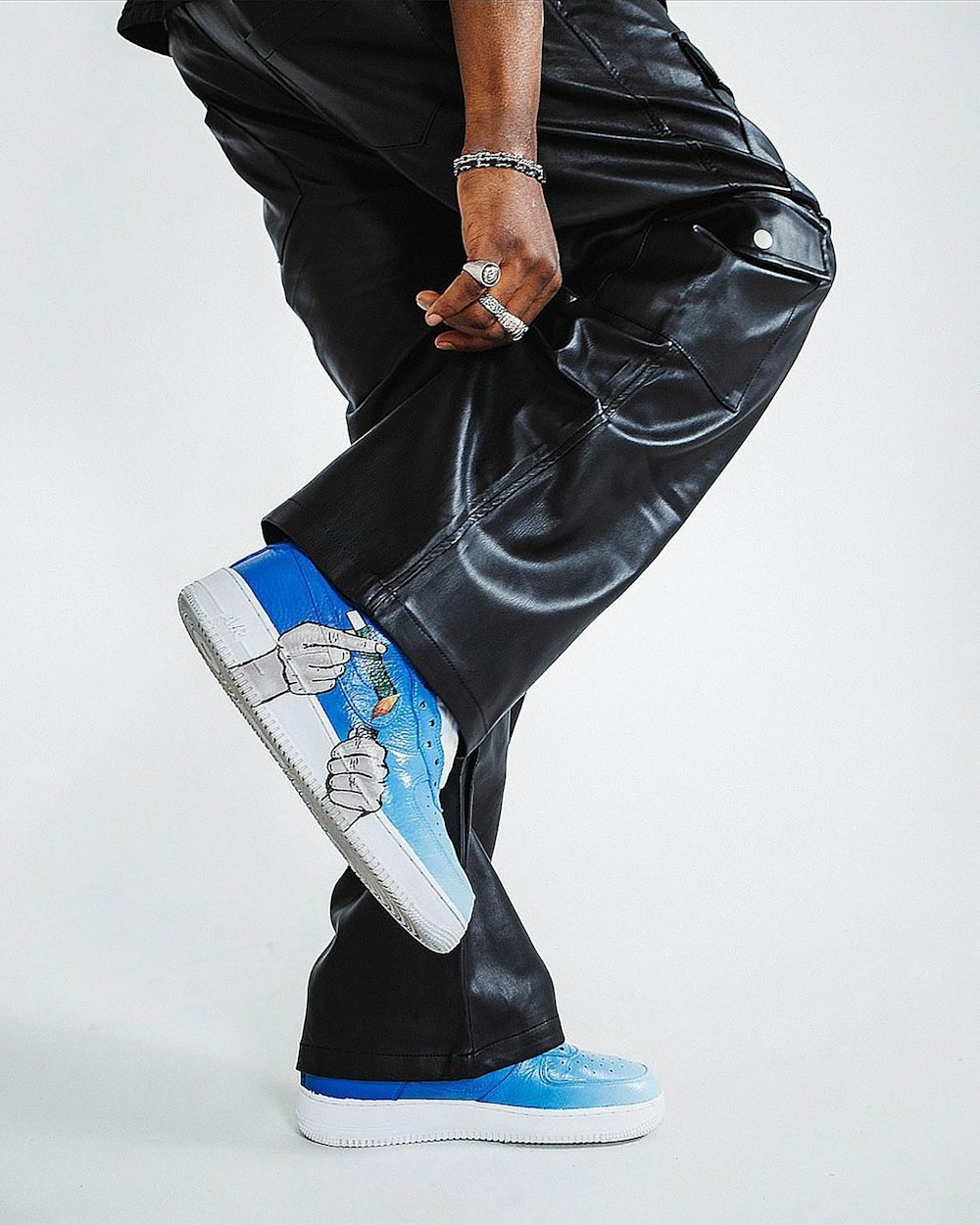 a man in black pants and a blue and white shoe