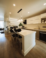 a kitchen with a center island with chairs