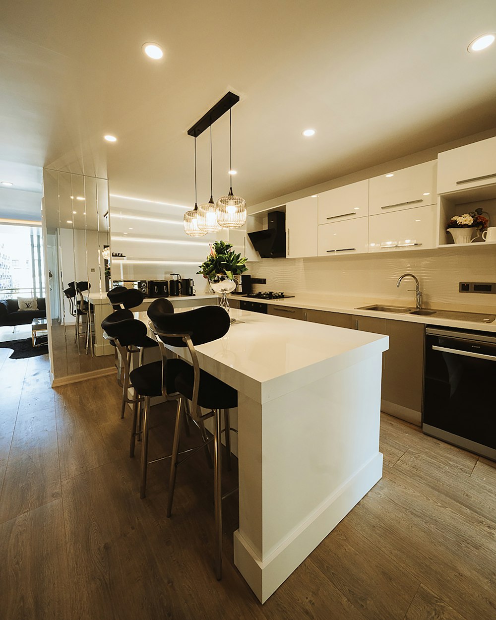 a kitchen with a center island with chairs