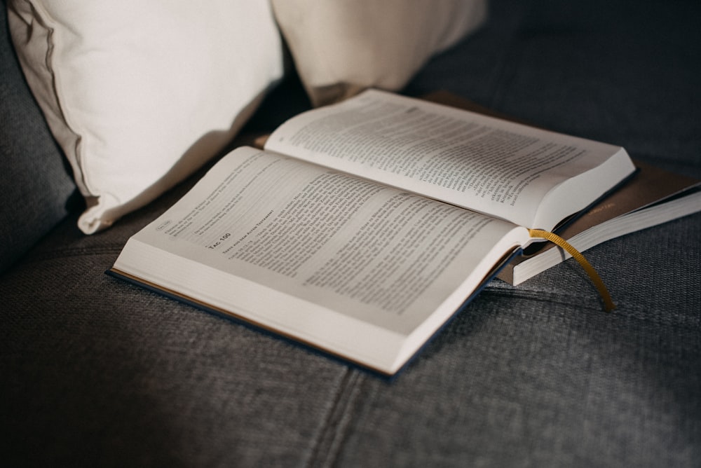 an open book sitting on top of a couch