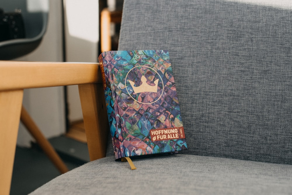 a book sitting on top of a gray chair