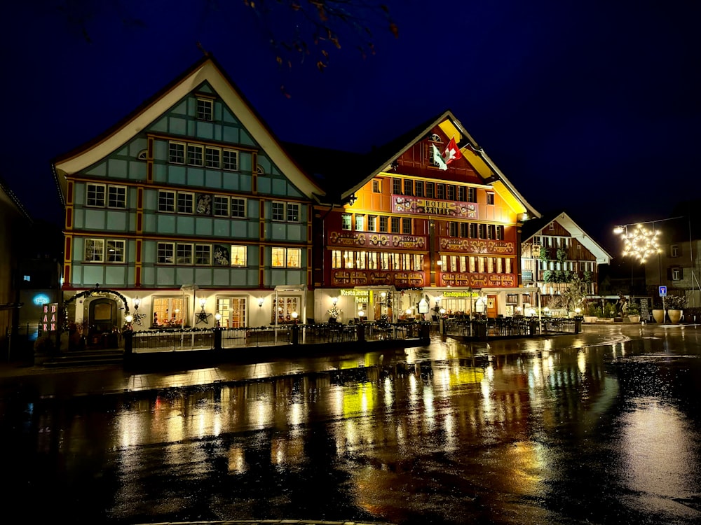 a night scene of a town with a river running through it