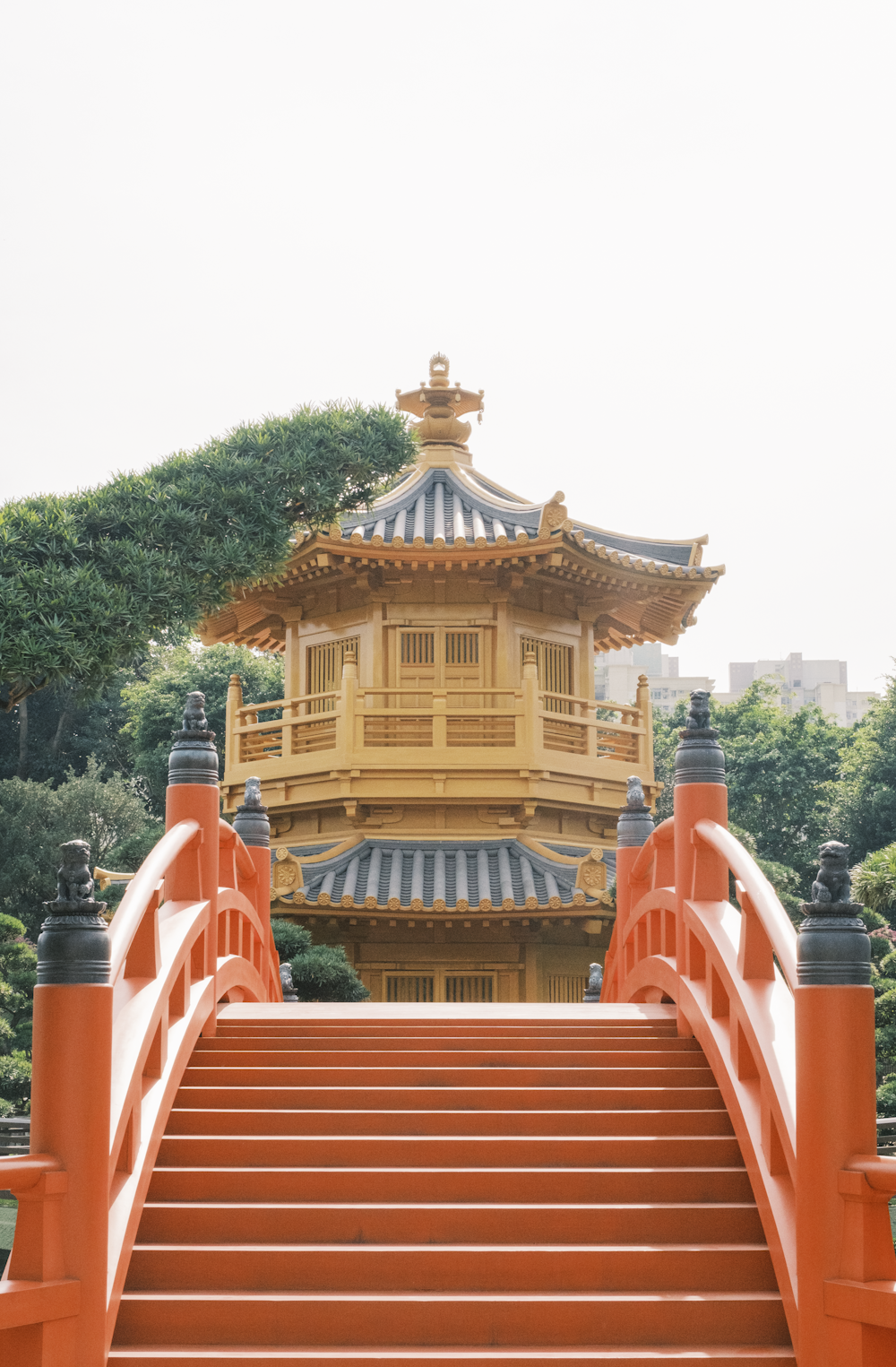 a yellow building with a red staircase leading up to it