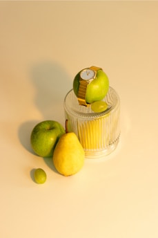 a couple of pears sitting on top of a cupcake