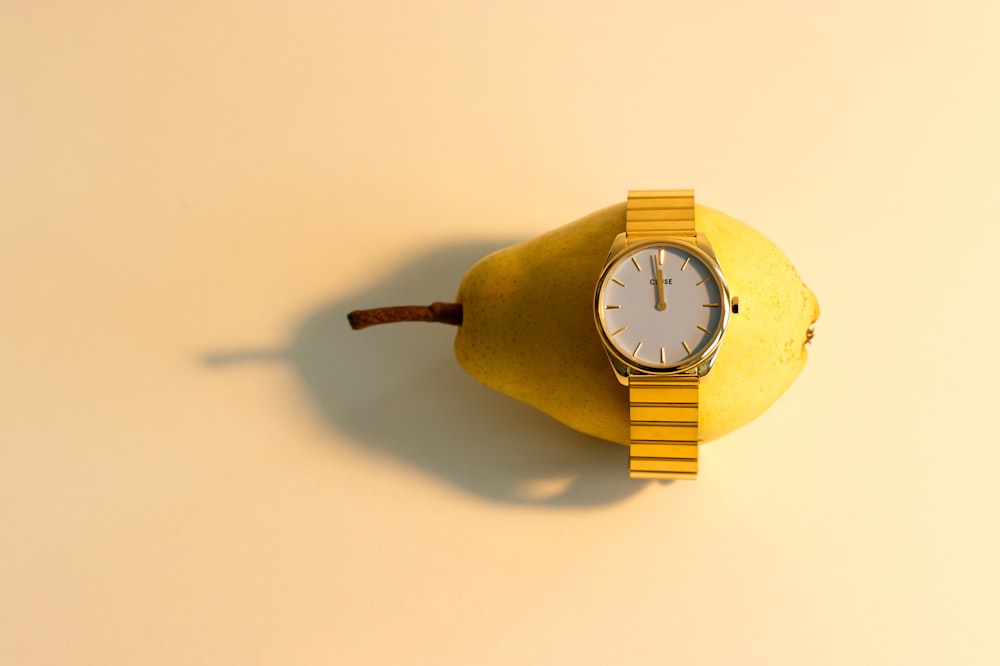 a watch sitting on top of a banana
