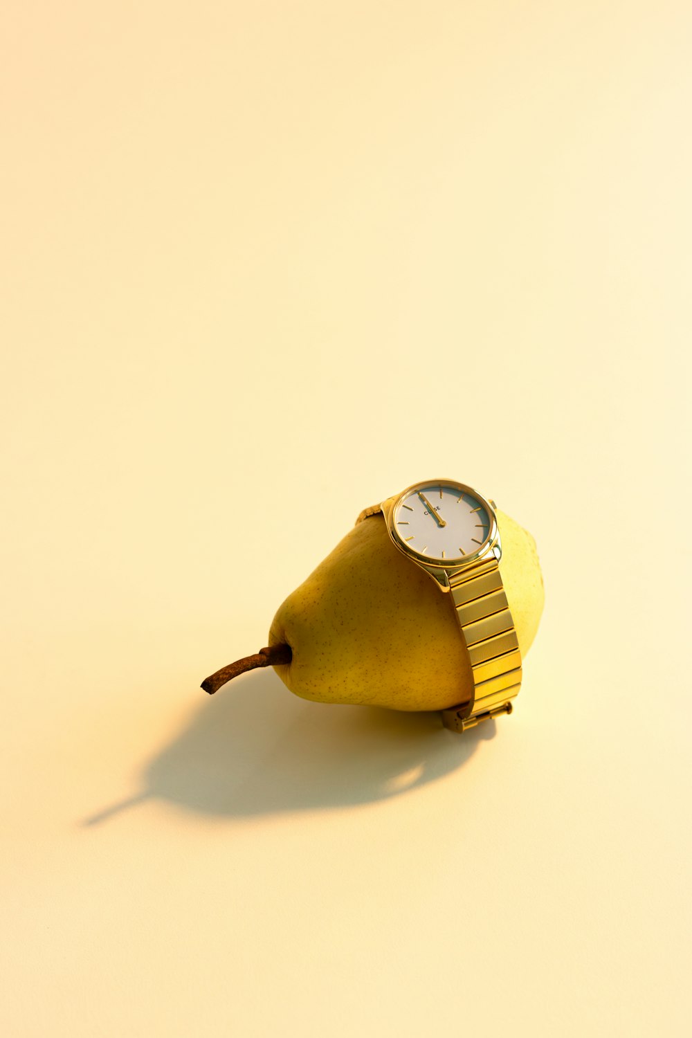 a pear with a watch on top of it