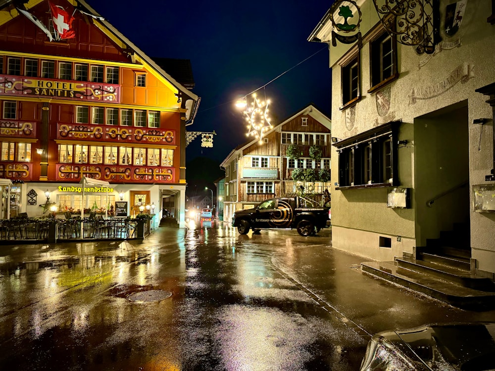a city street at night with lights and buildings