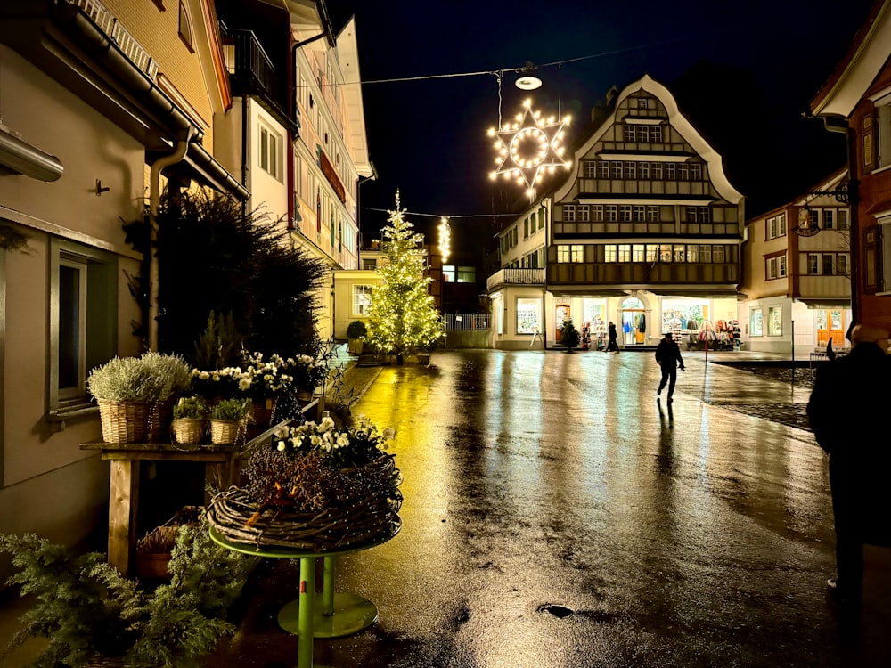 a person walking down a street at night