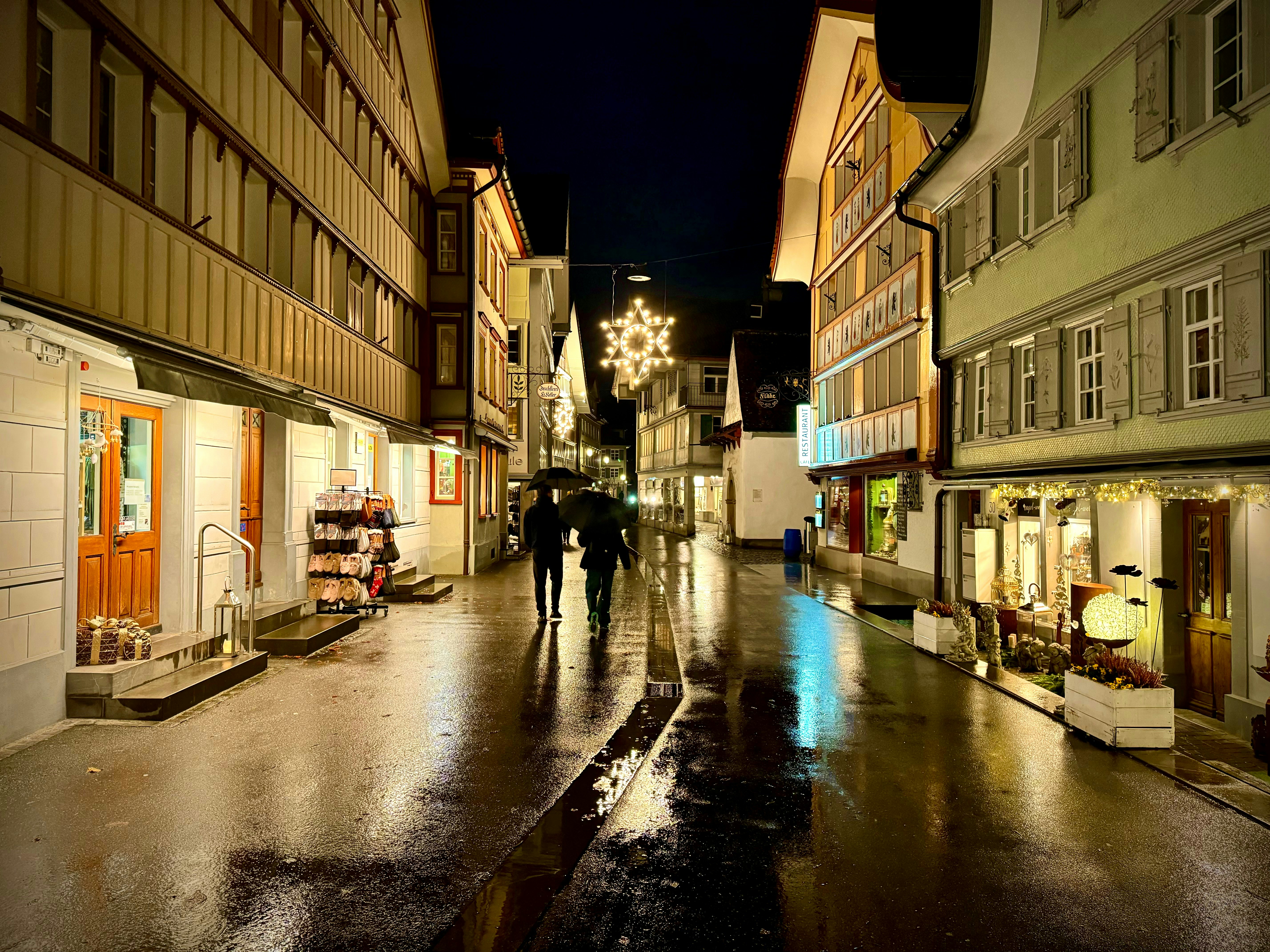 a couple of people that are walking down a street