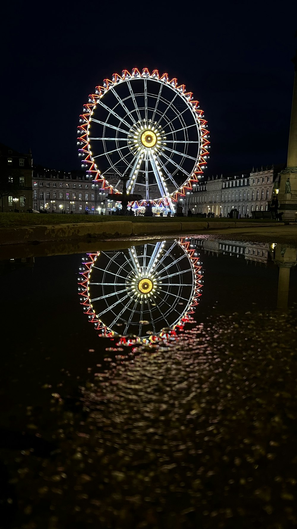 a ferris wheel is lit up at night