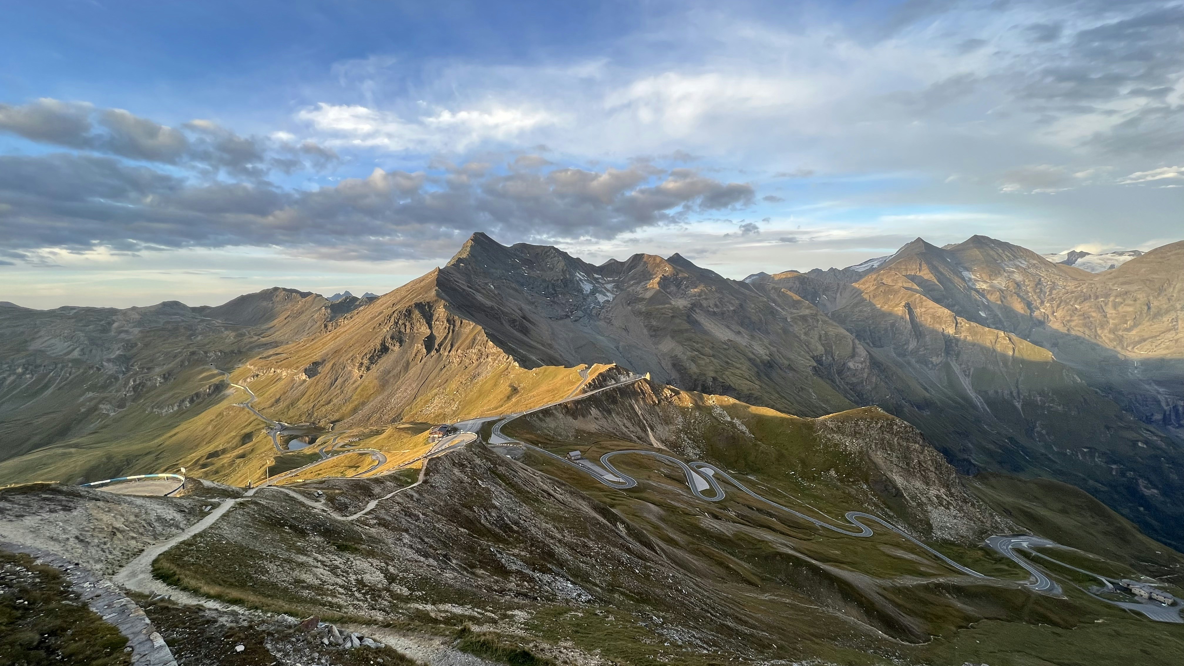 a scenic view of a winding road in the mountains