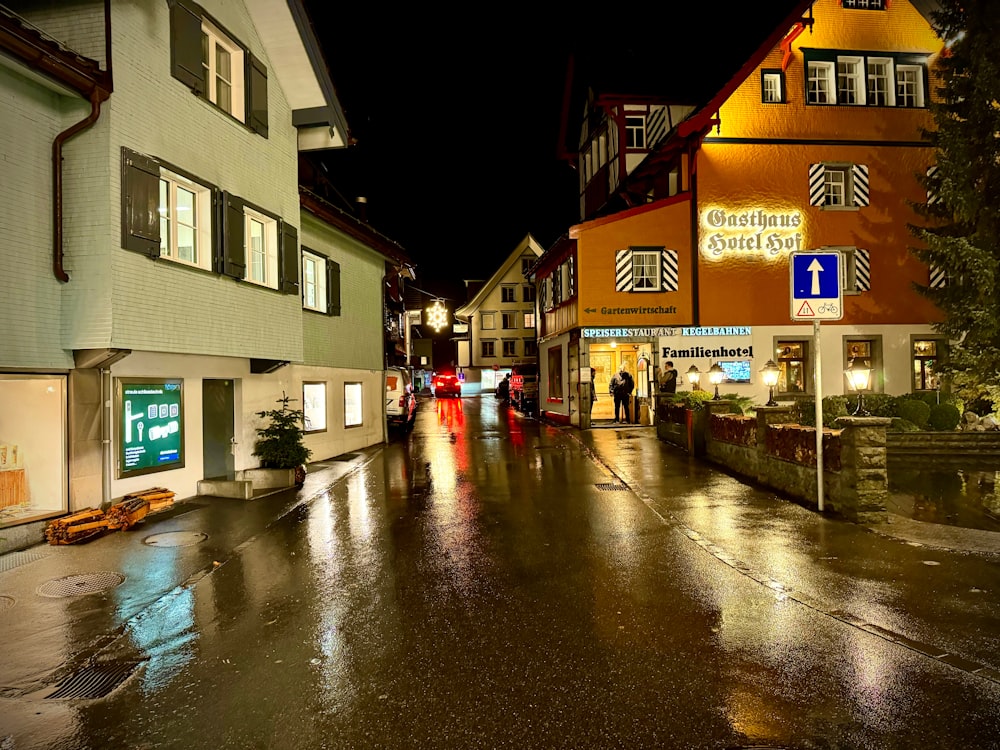 a city street at night with people walking down the street