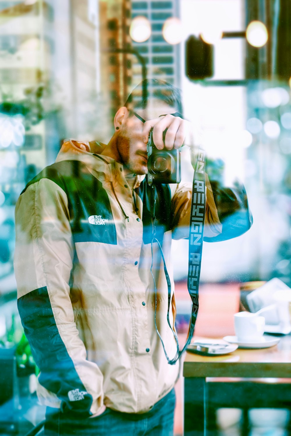 a man taking a picture of himself through a window