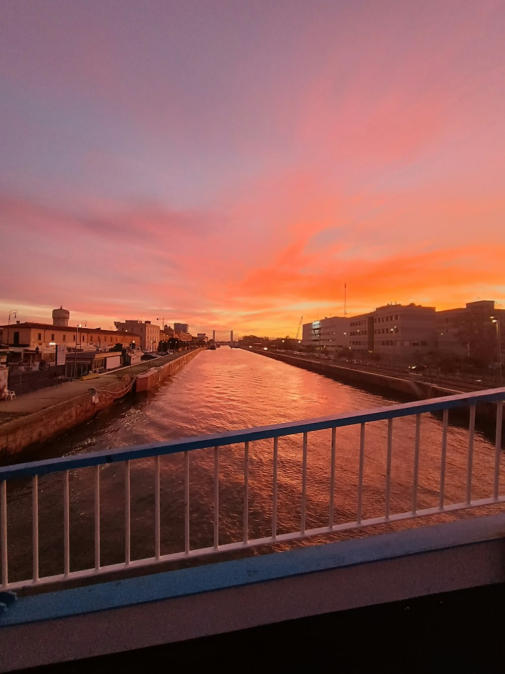 a view of a river at sunset from a bridge