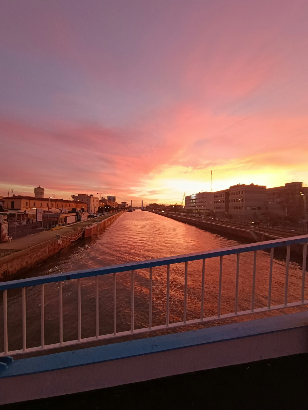 the sun is setting over a body of water