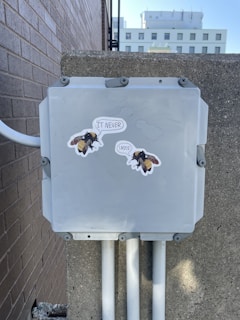 a gray box with stickers on the side of it