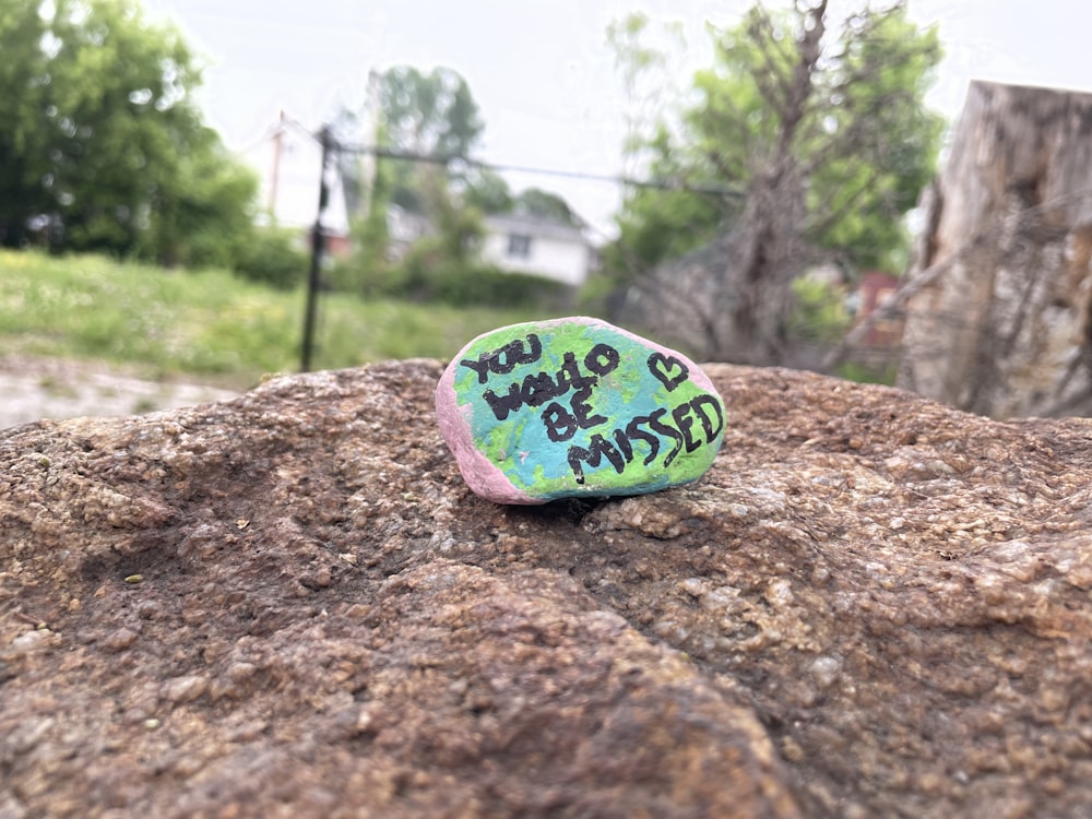 a rock with graffiti written on it