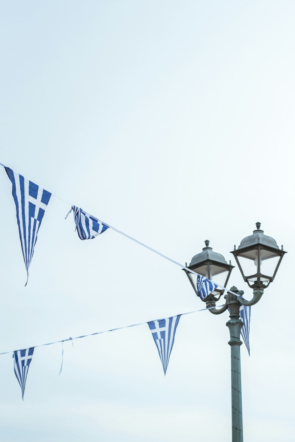 Blau-weiße Fahnen, die an einer Straßenlaterne hängen