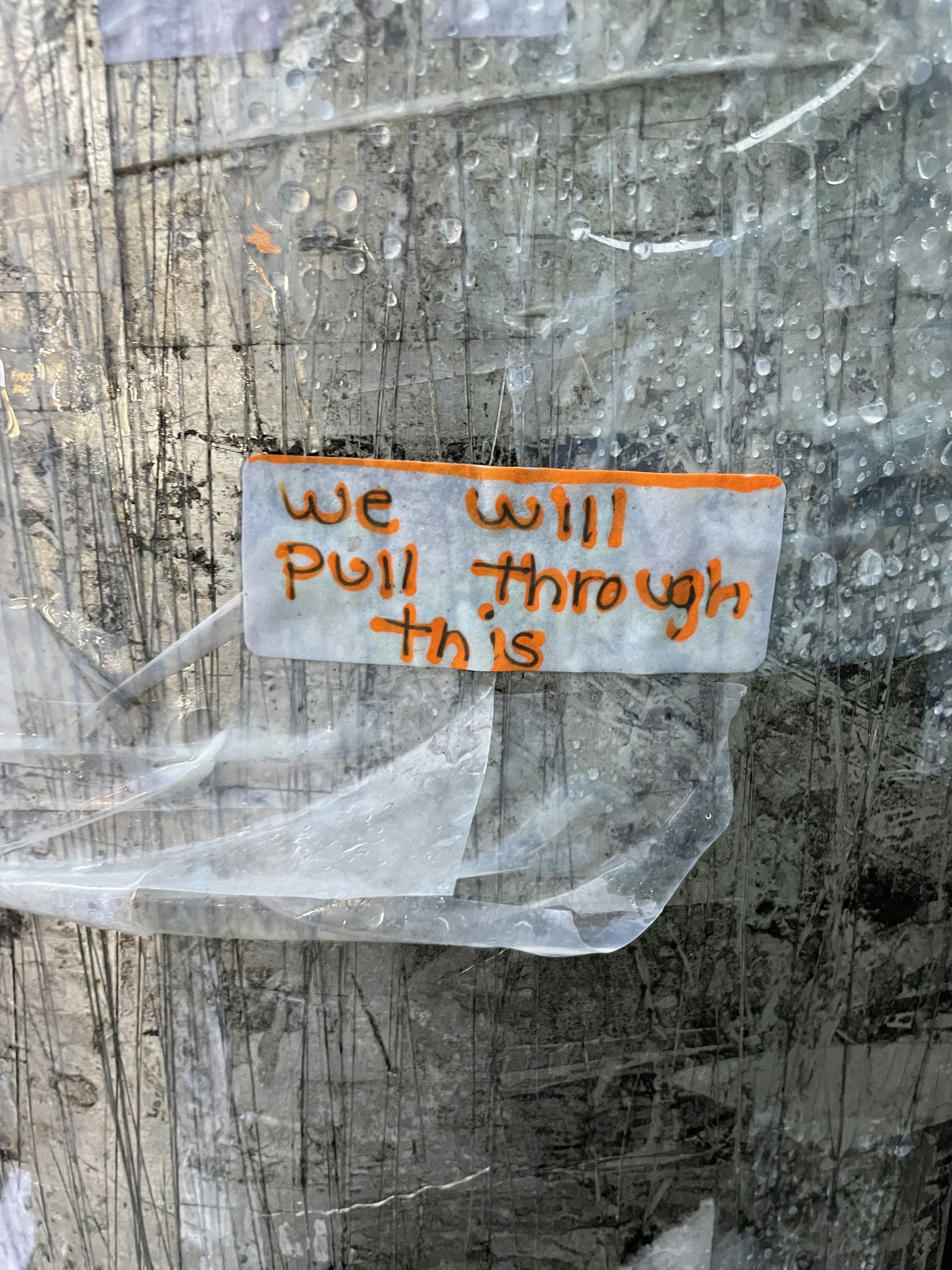 a sign on a door that says we will pull through this
