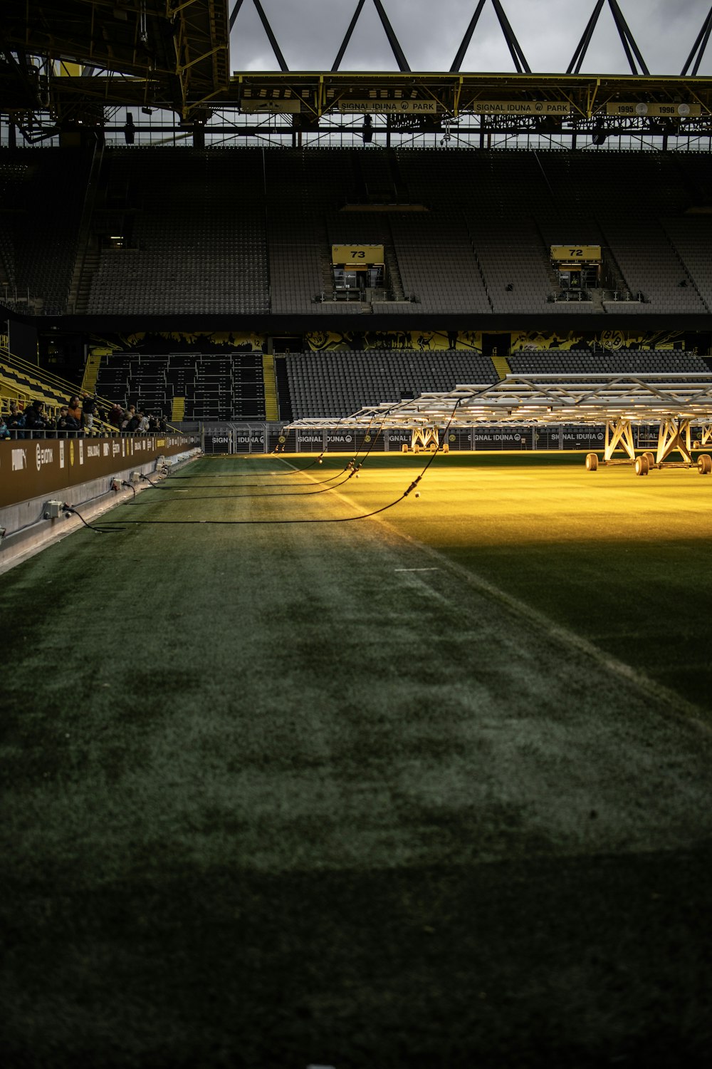 a large empty stadium with a yellow field