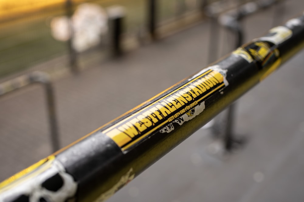 a close up of a yellow and black baseball bat