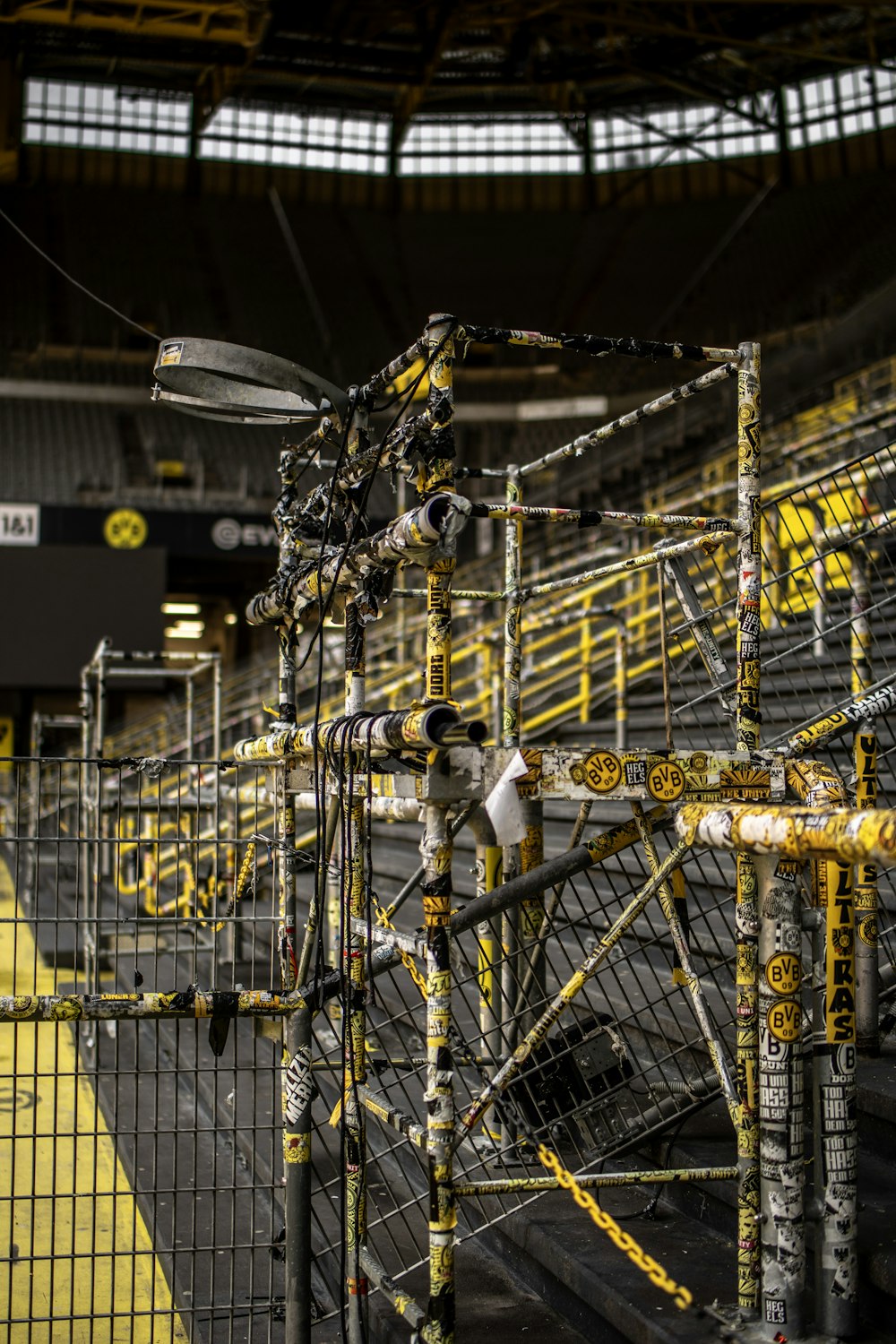 the inside of a stadium filled with yellow and black equipment