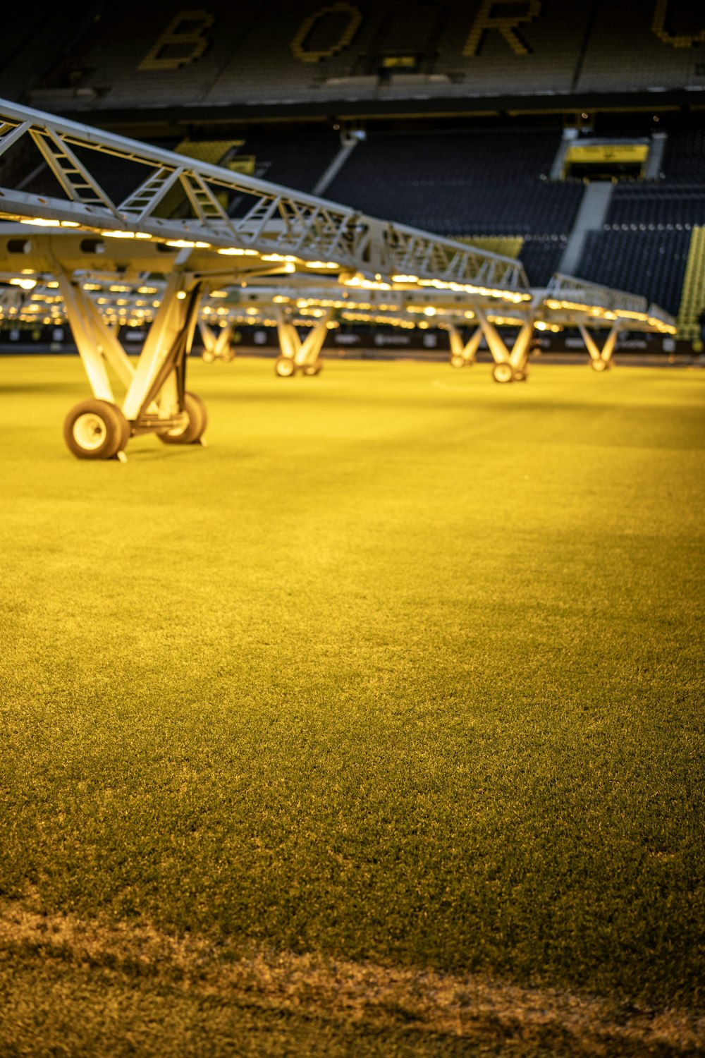 an empty stadium with a row of stands