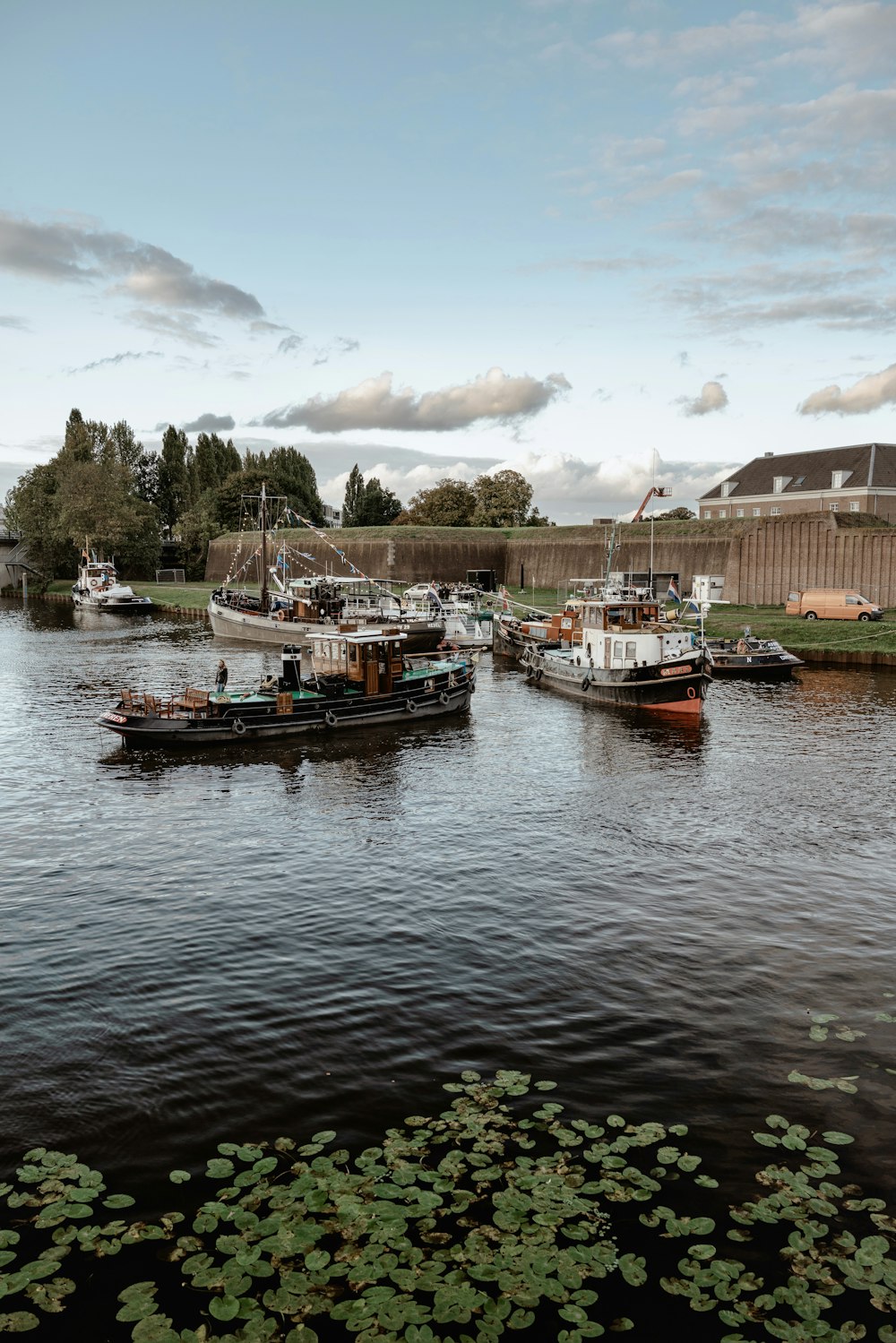 a group of boats floating on top of a river