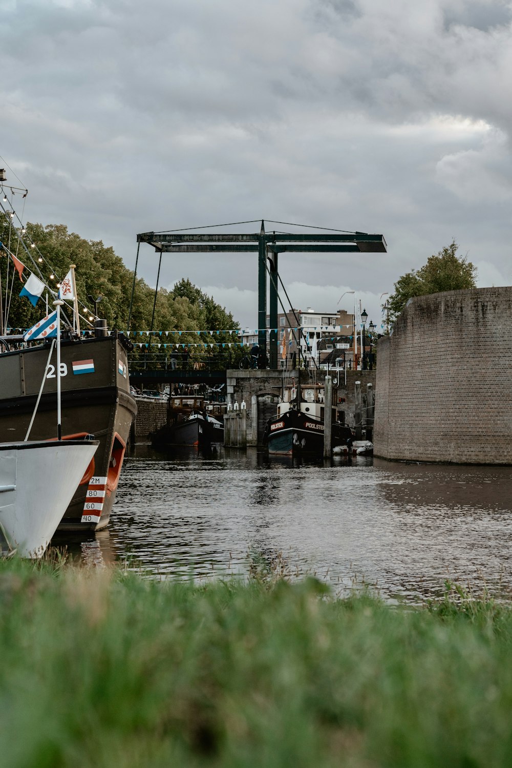 a boat sitting in the water next to a bridge