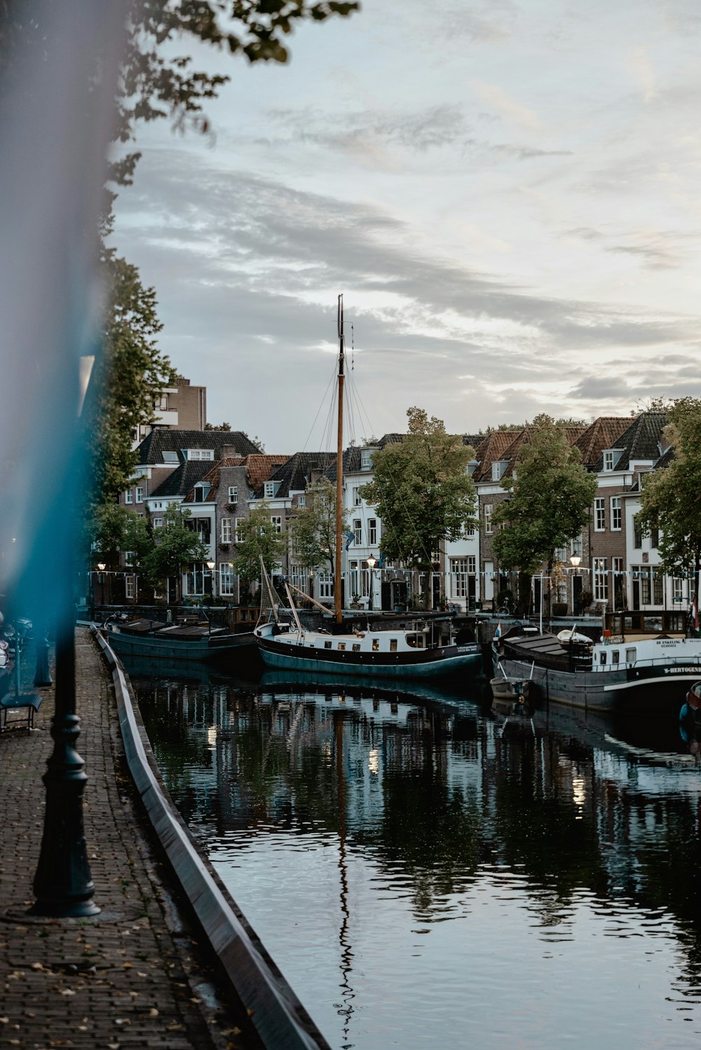 several boats are docked in the water near a row of houses