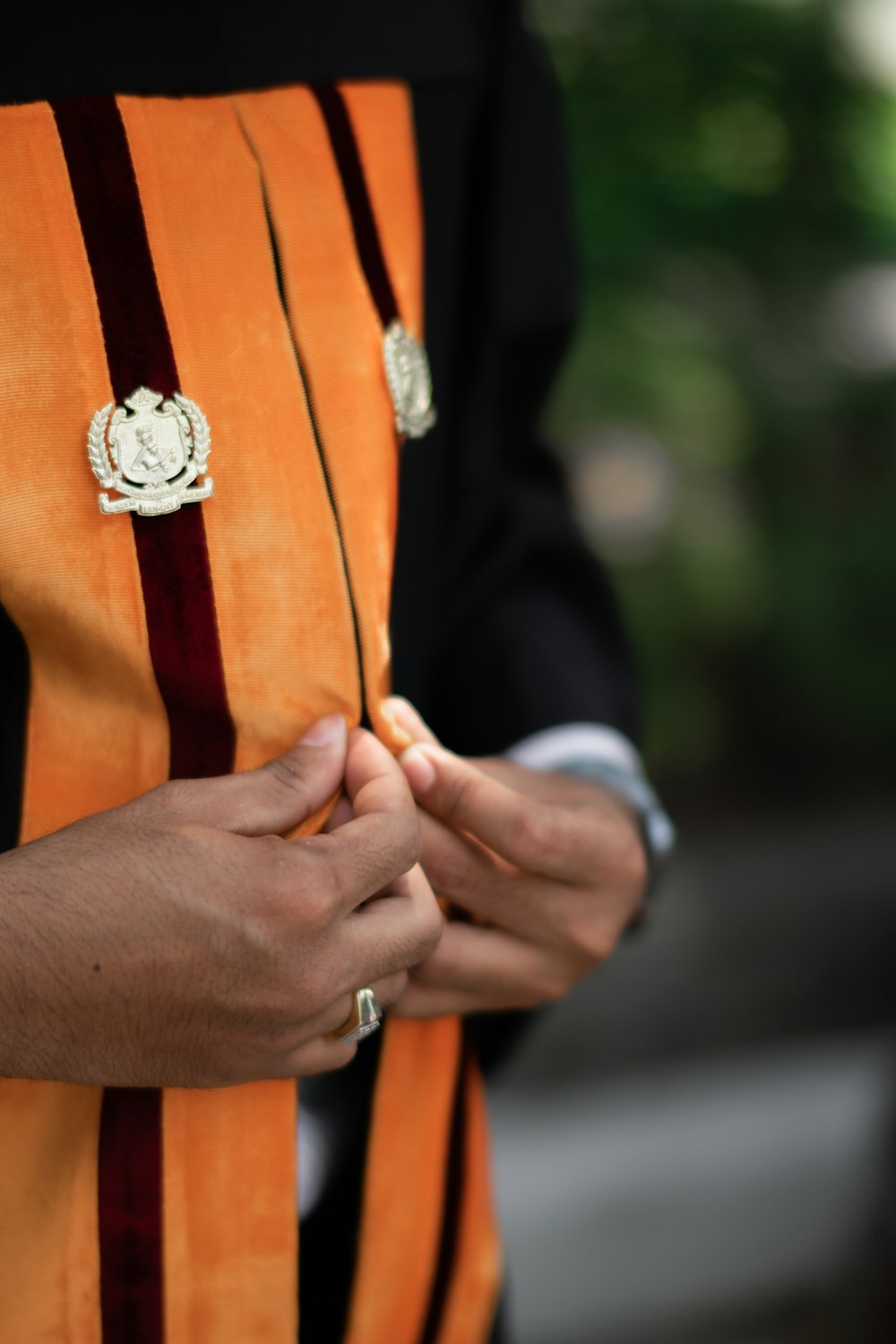 a person wearing a priest's robe and holding a cell phone