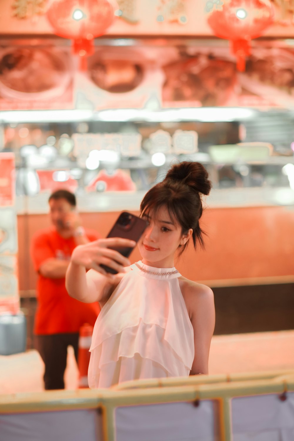 a woman taking a picture of herself in a mirror