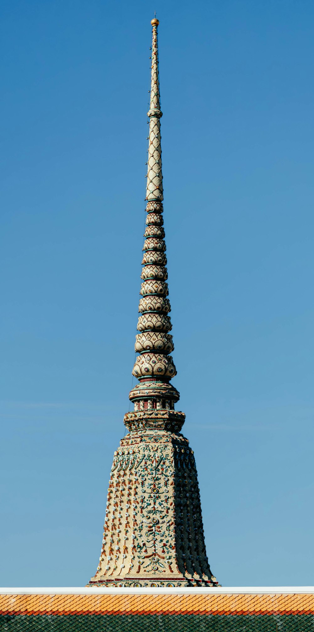 a very tall tower with a clock on it's side