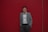 a man standing in front of a red wall
