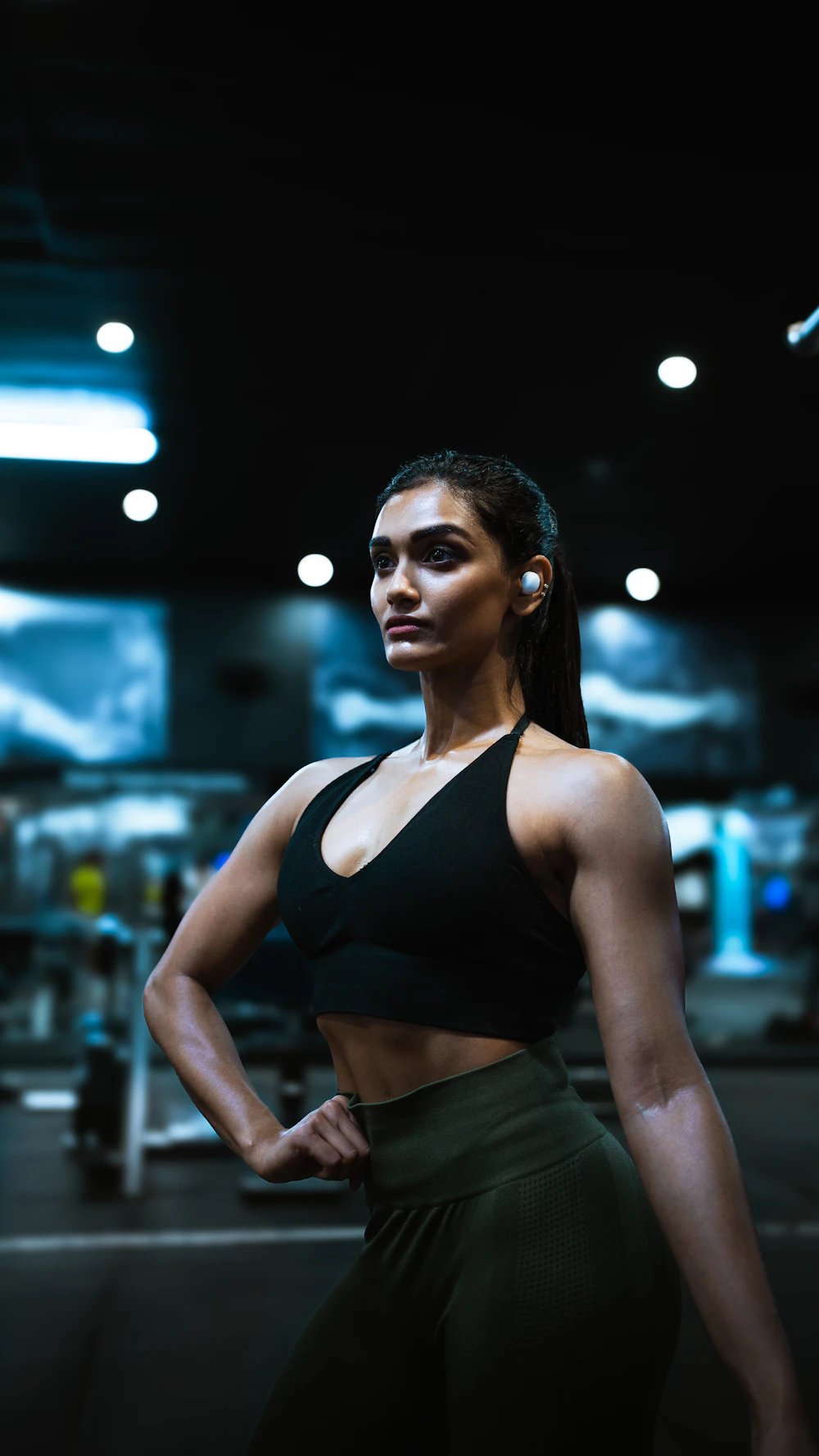 Retrato de Maya Torres, coach principal, de pie con seguridad en el gimnasio.