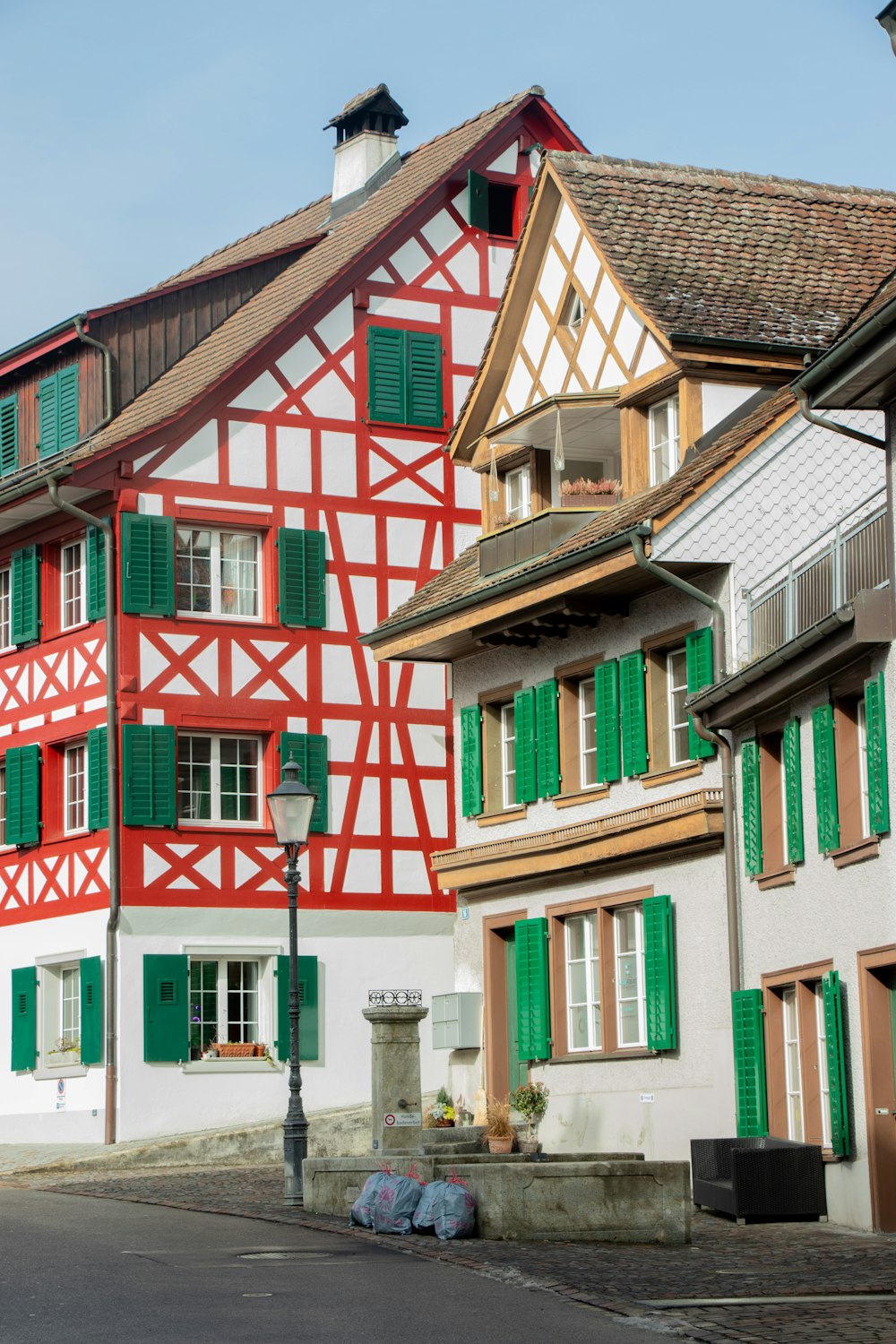 a red and white building with green shutters