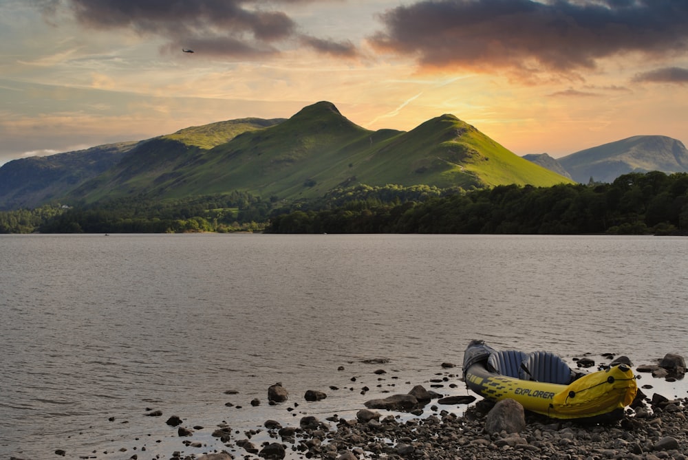 a banana boat on the shore of a lake