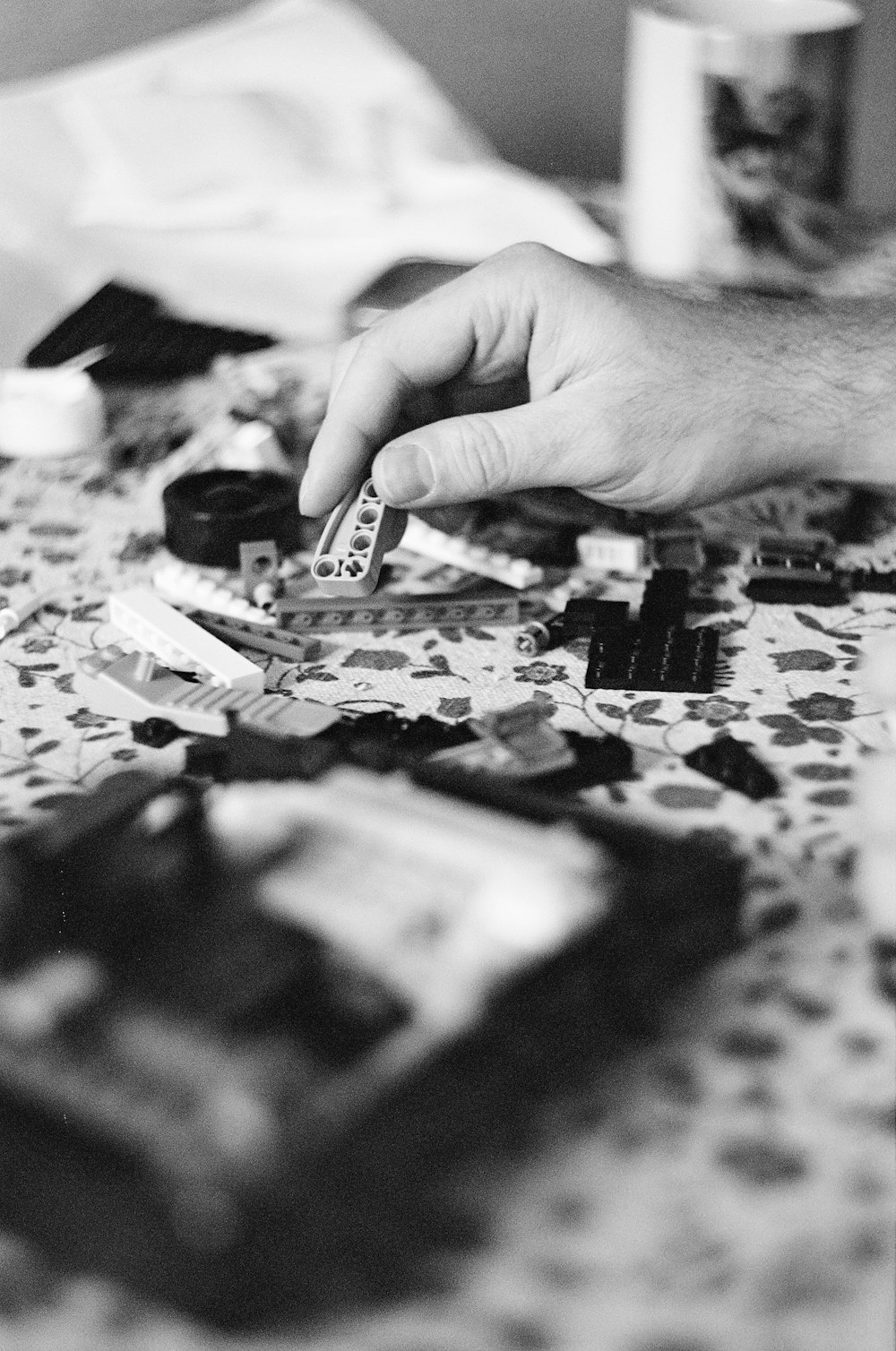 a person holding a piece of paper over a table