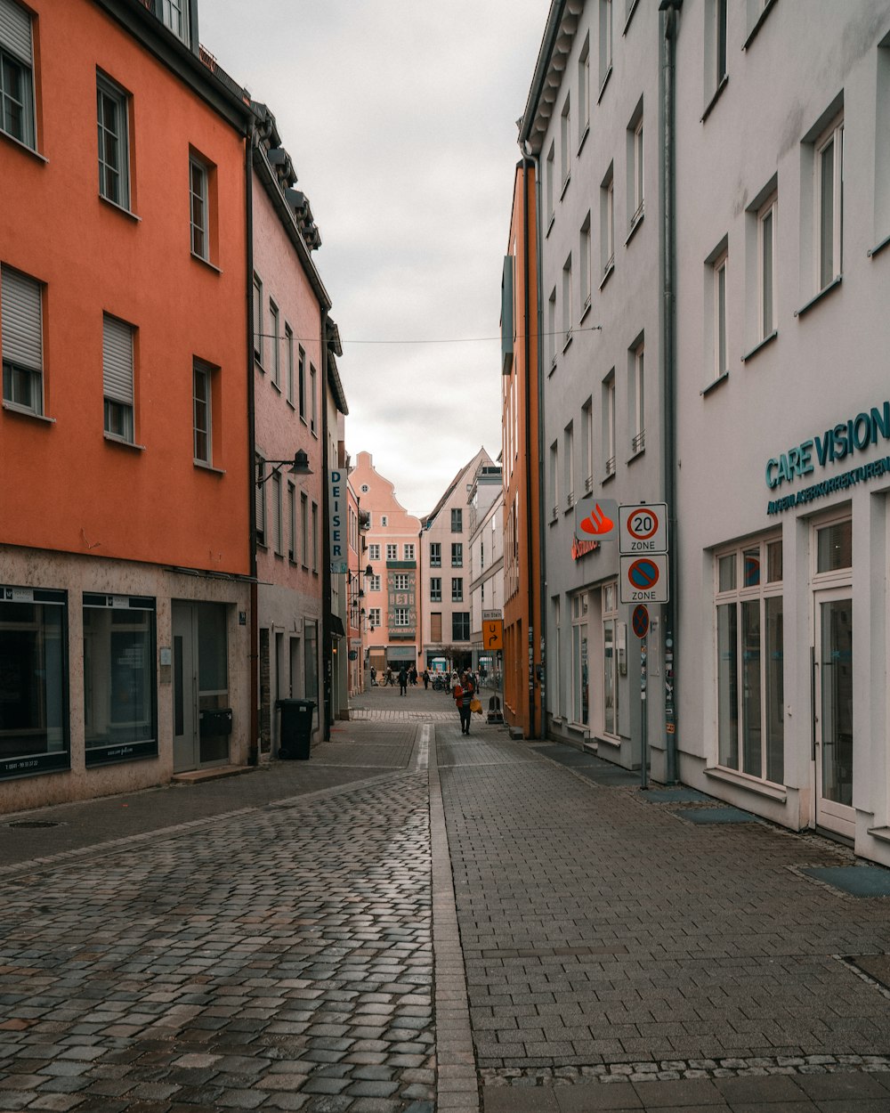 a cobblestone street lined with tall buildings