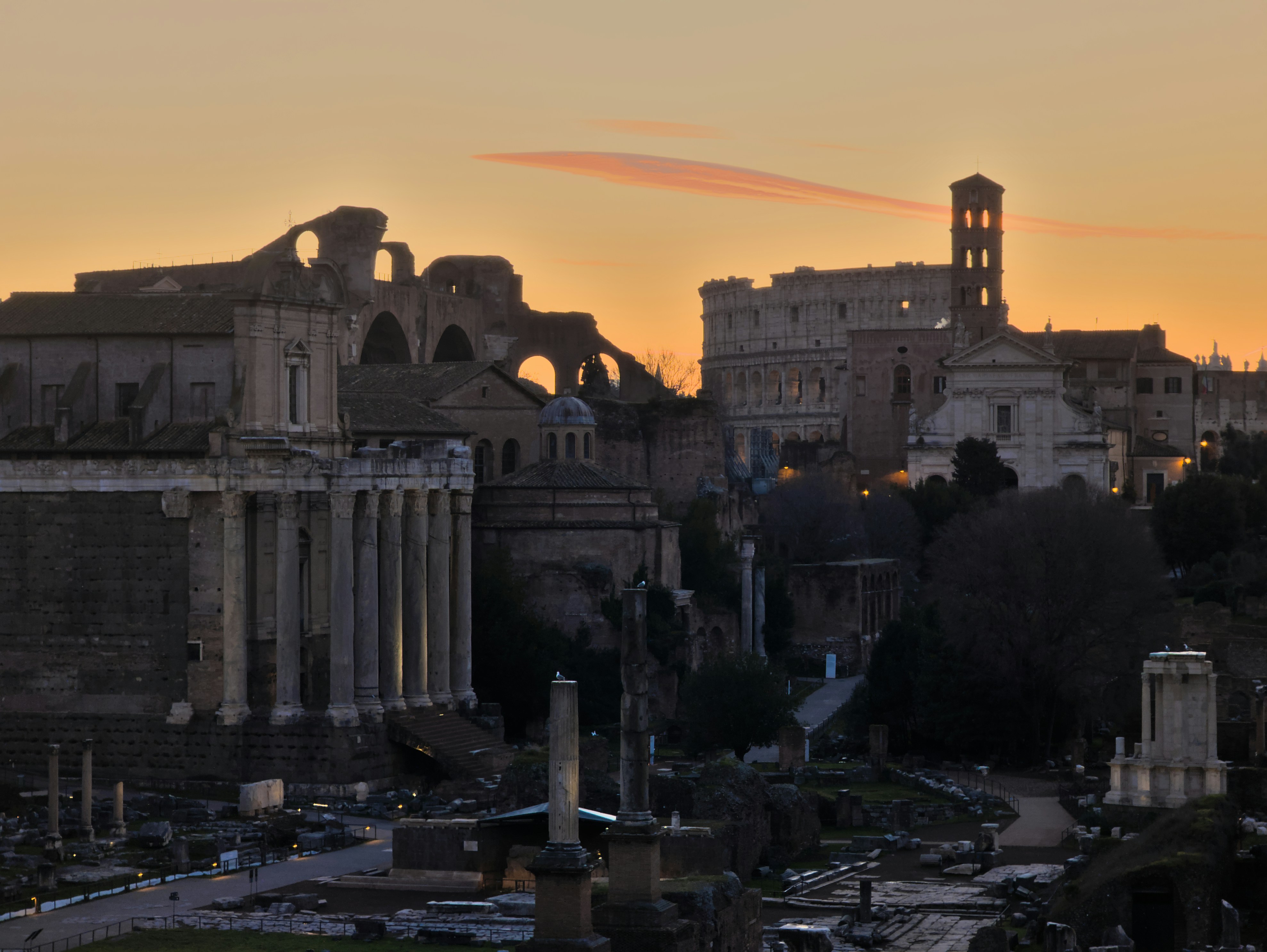 A breathtaking view of the forum romanum with the Colosseum in the background at sunrise. Roma/Rome, Italy