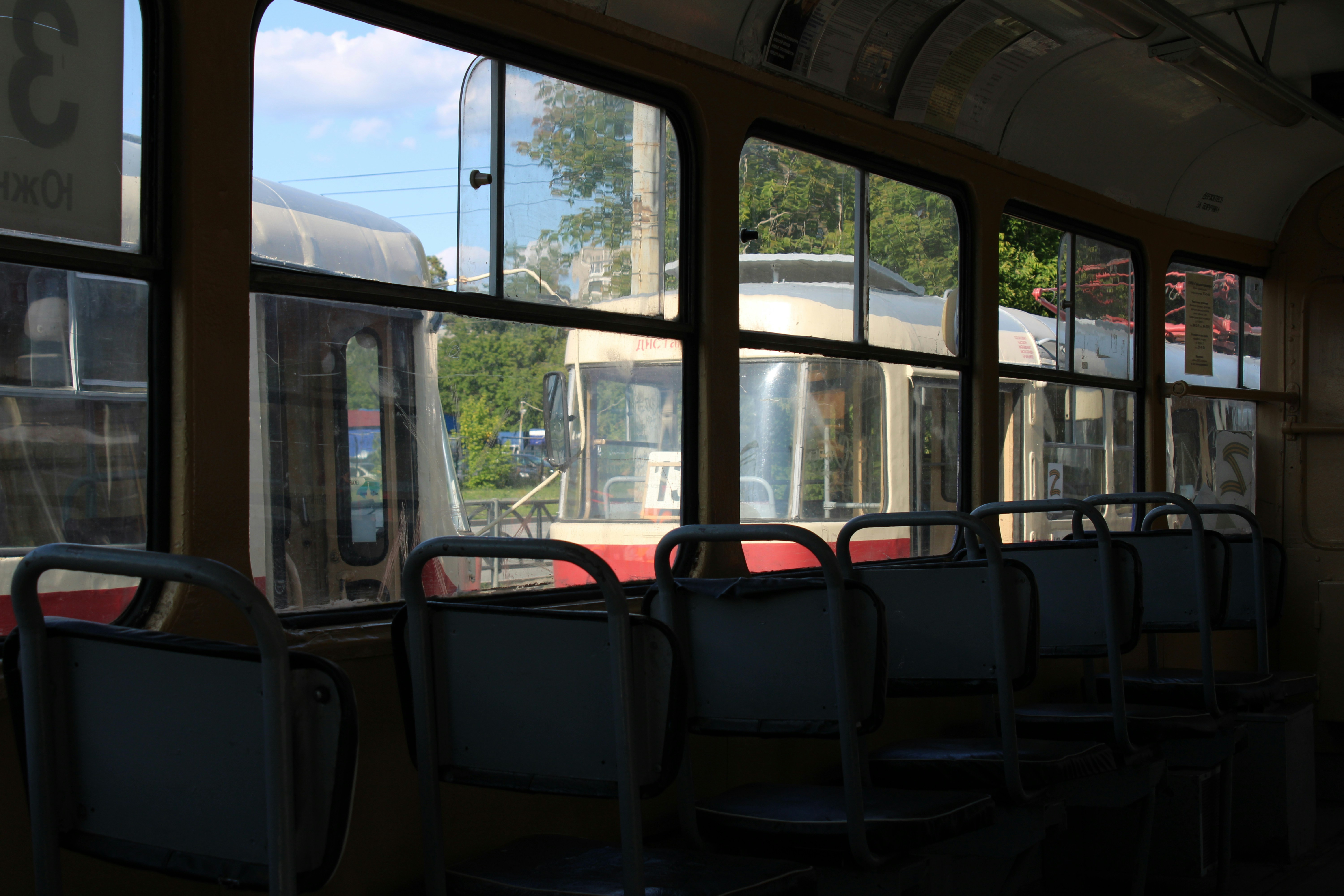 a row of empty seats sitting next to a window